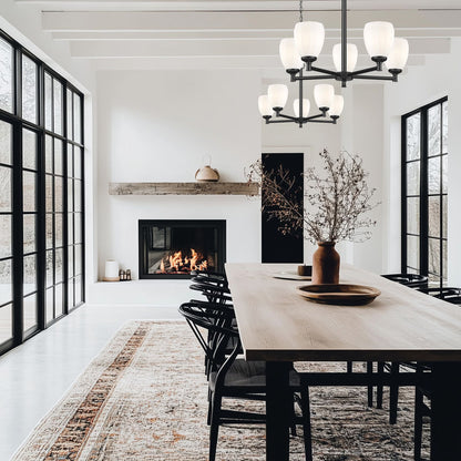 modern steel chandelier in matte black over dining table interior.