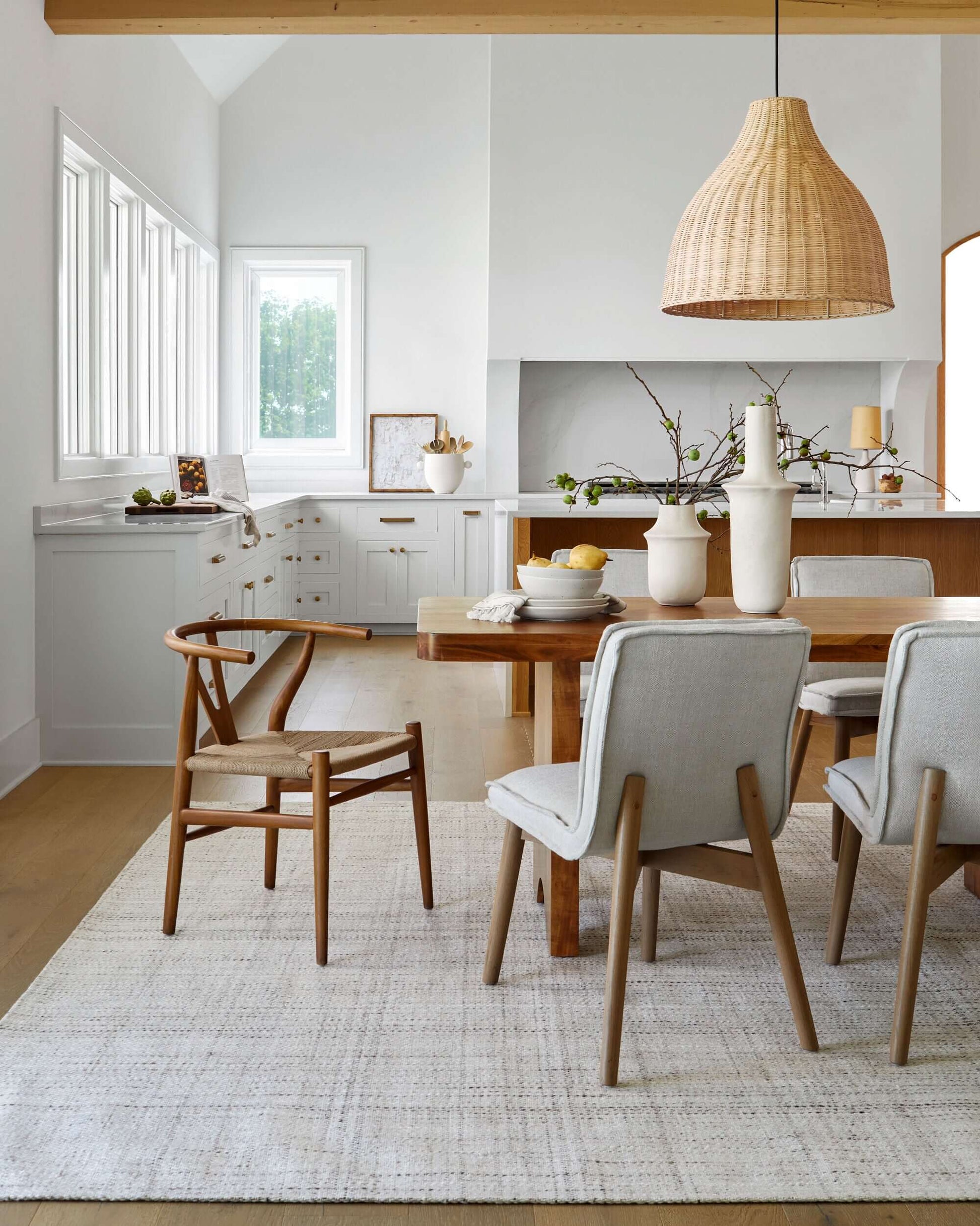 The Joiner Dining Table in a bright, airy kitchen setting, paired with light-colored dining chairs.