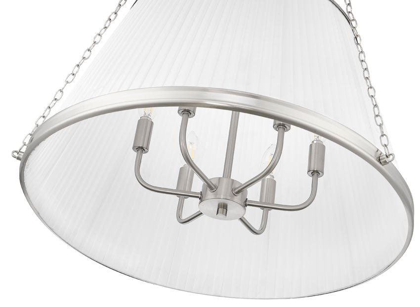 close-up of brushed nickel pendant light showing candelabra bulbs under white pleated shade.