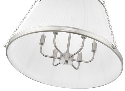 close-up of brushed nickel pendant light showing candelabra bulbs under white pleated shade.