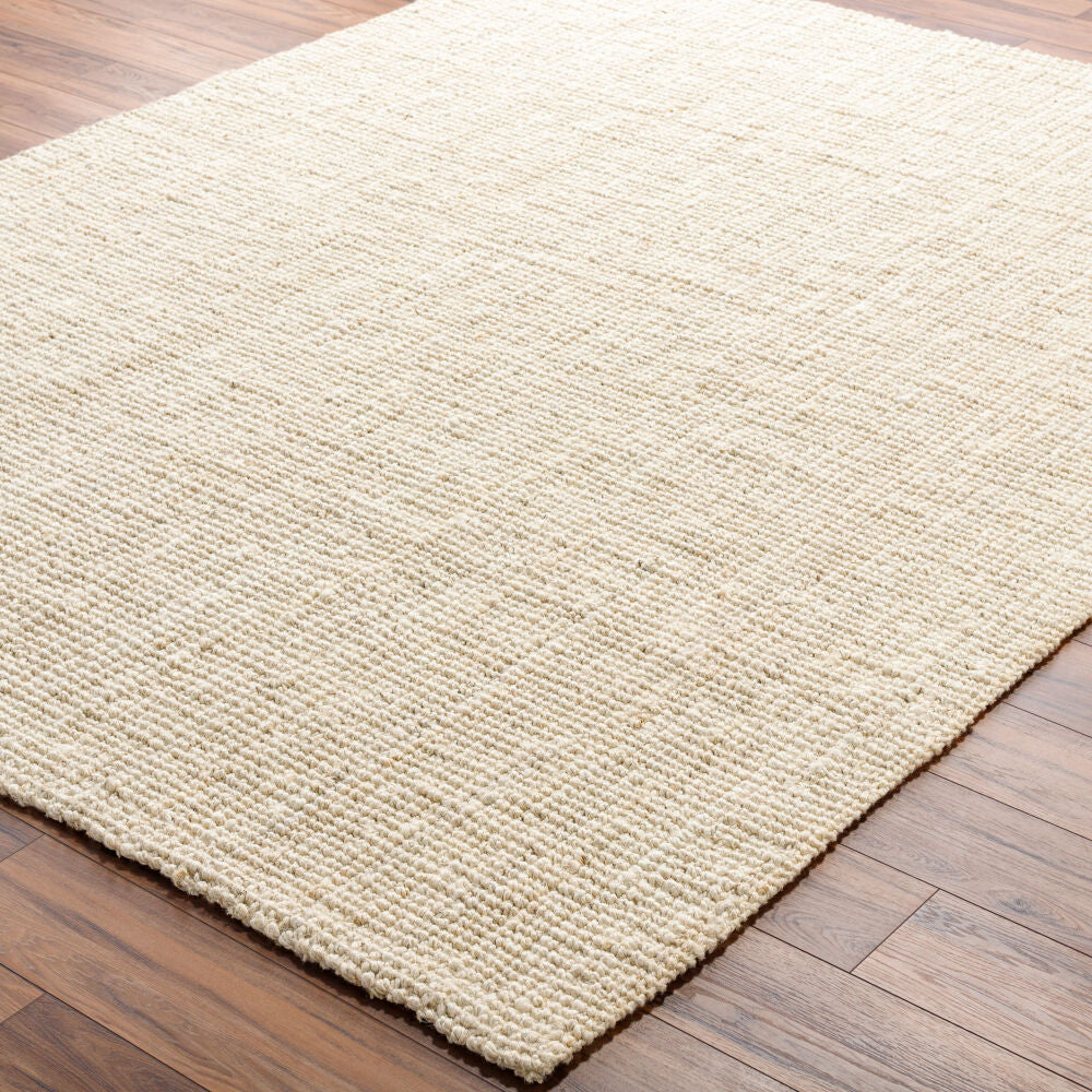 Butter jute rug on hardwood flooring, showing rustic texture and cozy appeal.