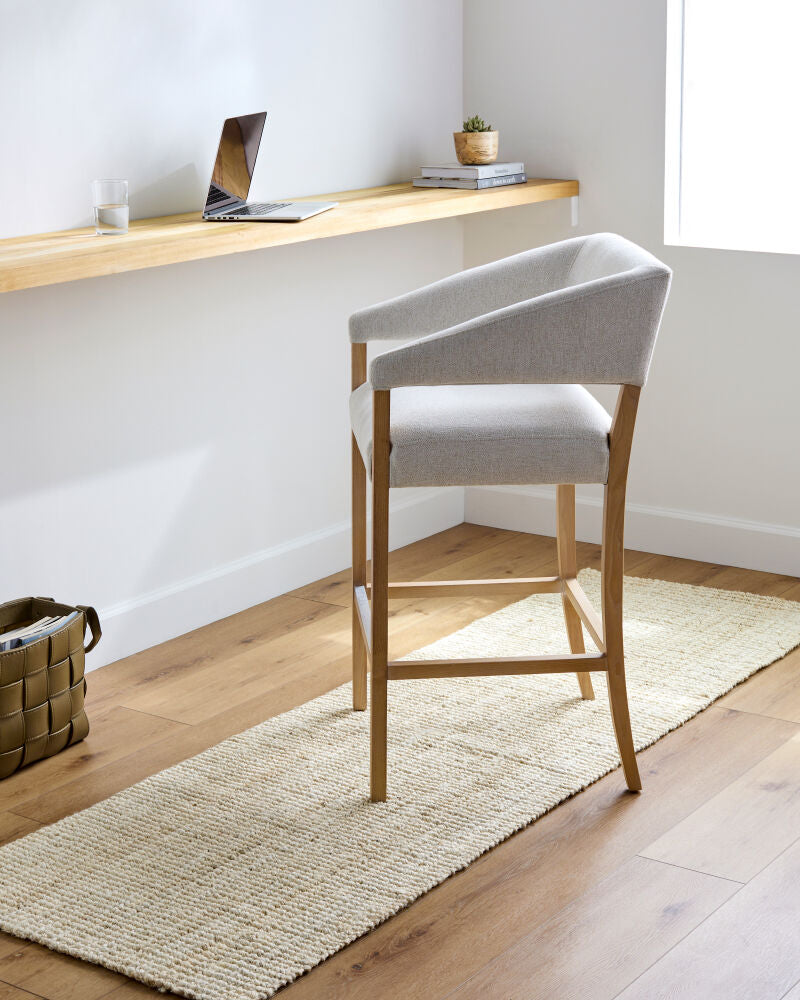 Butter jute runner under a chair in a bright workspace with natural wood tones.