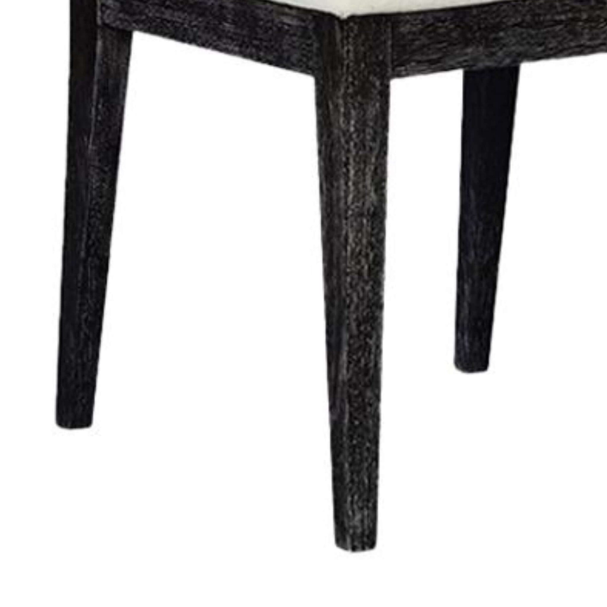 Detail of the sturdy, tapered legs on Caine I black dining chair in Midnight finish.