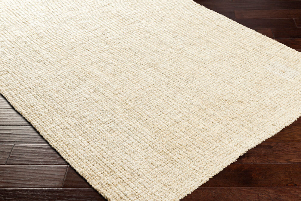Warm, textured rug in butter hue enhancing wooden flooring.