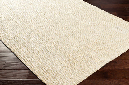 Warm, textured rug in butter hue enhancing wooden flooring.