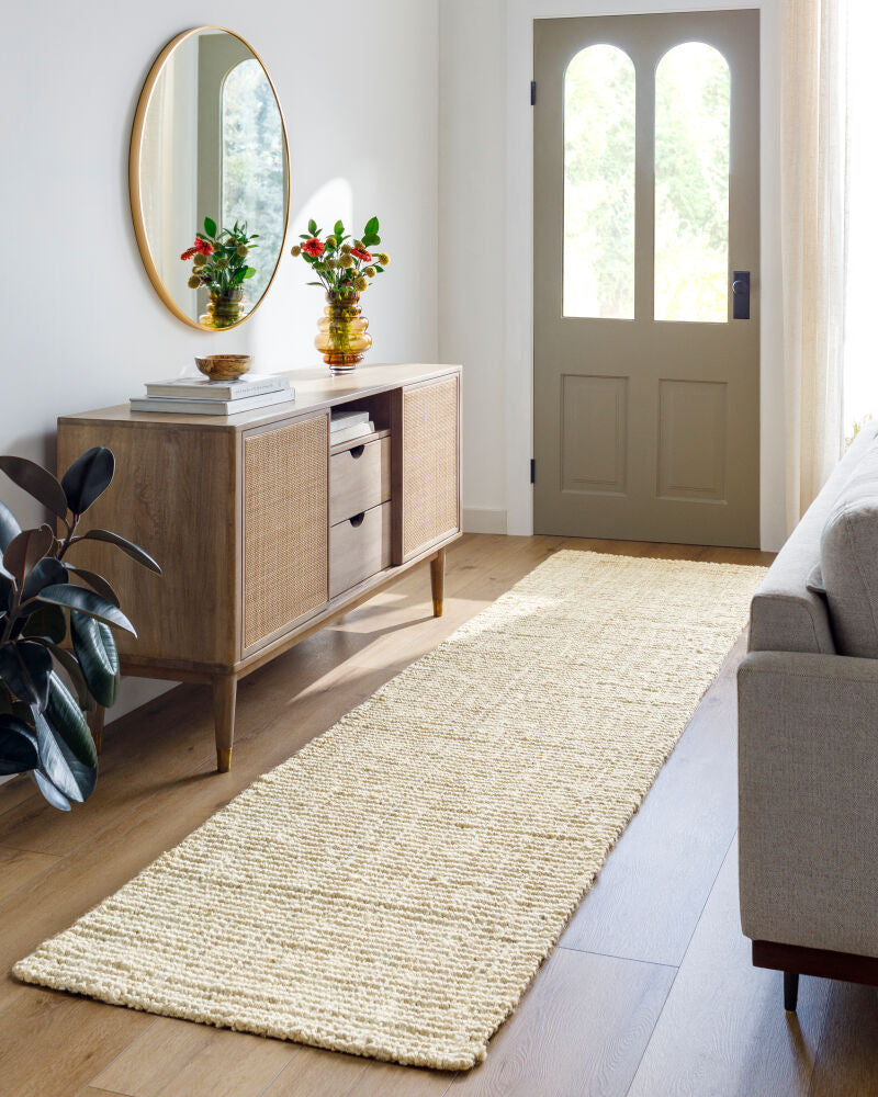 Long runner rug accentuating an entryway with a modern console table.