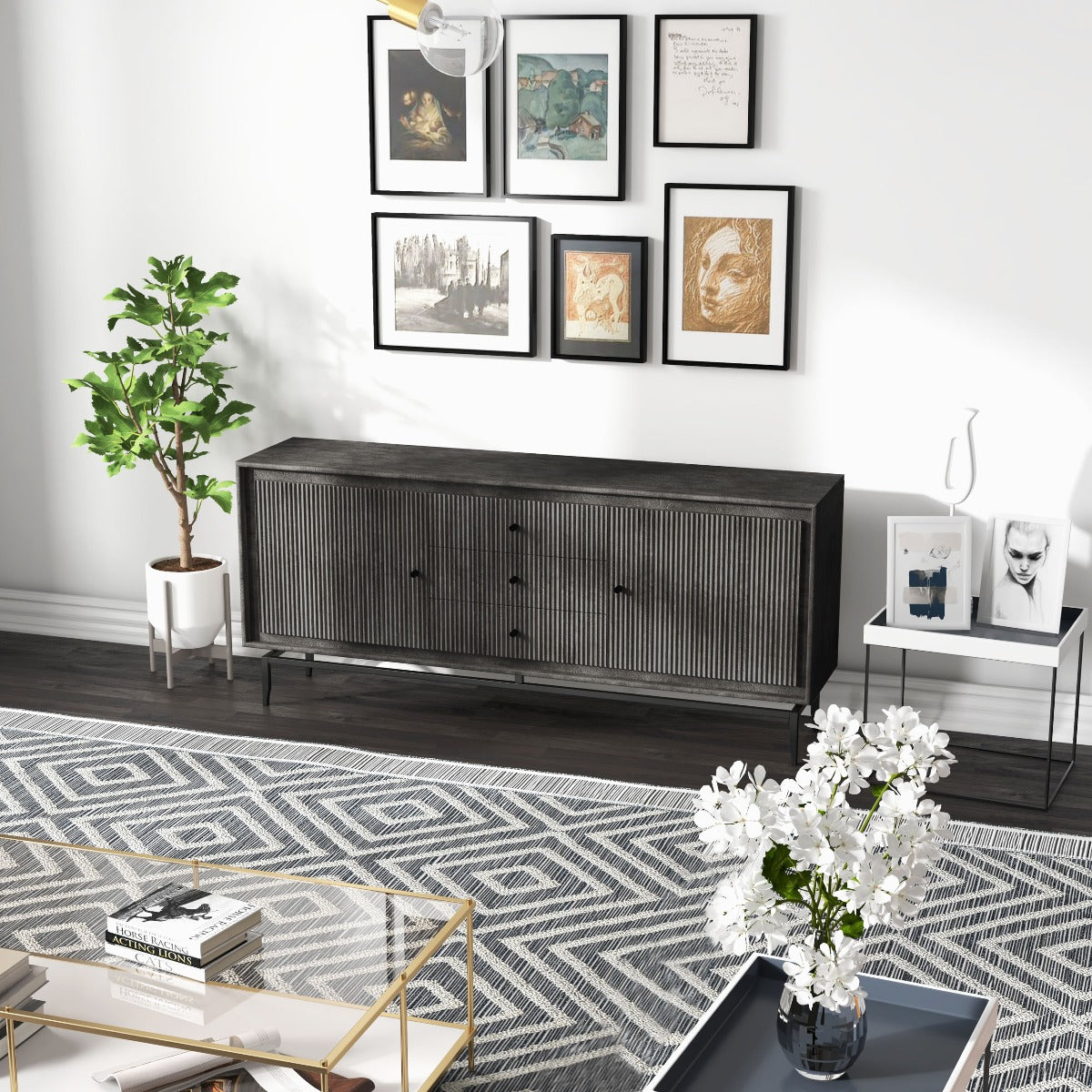 Wide shot of black sideboard in a bright living room, styled with a green plant and gallery wall.