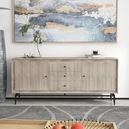 Fluted grey sideboard with black handles, styled with a bold abstract painting in a modern space.