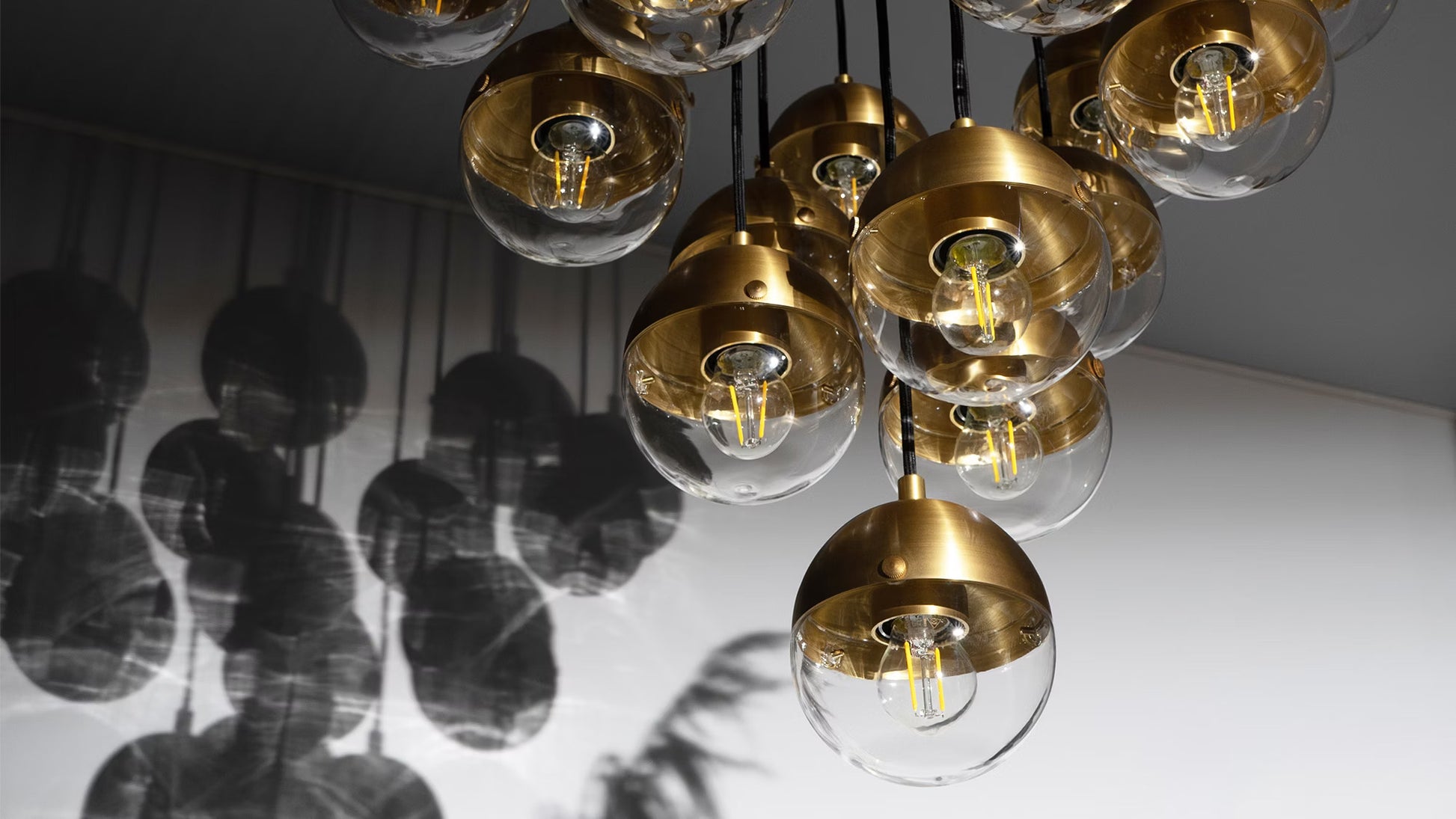 Close-up of handblown glass globes and burnished brass finish.