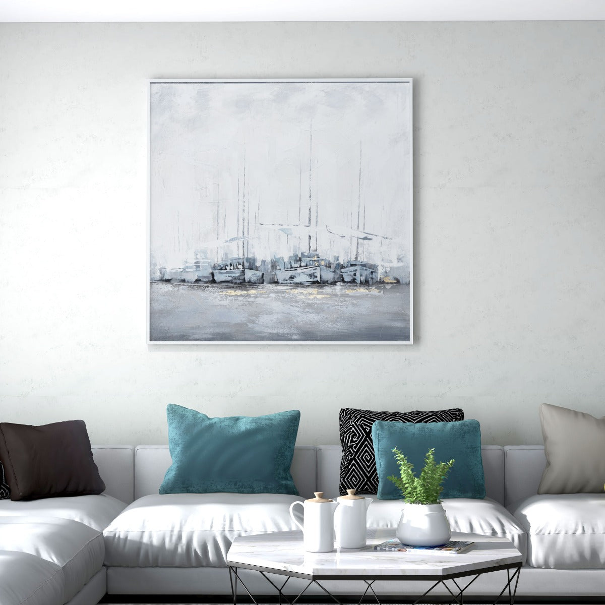 Coastal-themed wall art displayed above a modern sofa with blue cushions.