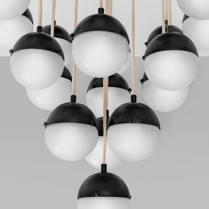 Closeup of the Black gunmetal chandelier with frosted globes and natural rods.