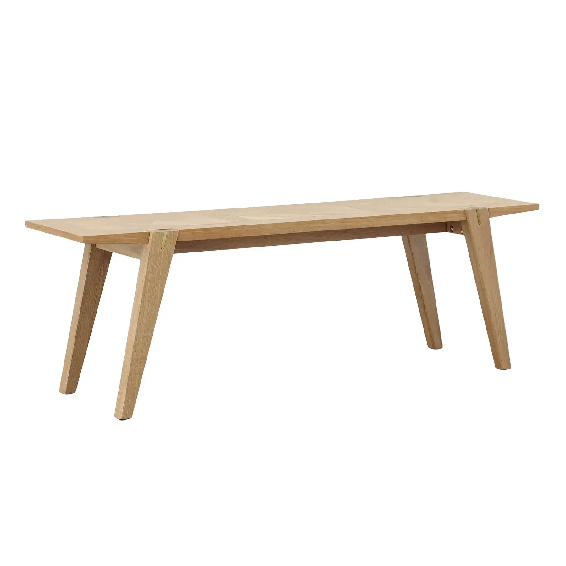 Colton oak wood dining bench with brass accents, angled legs, and a natural finish.