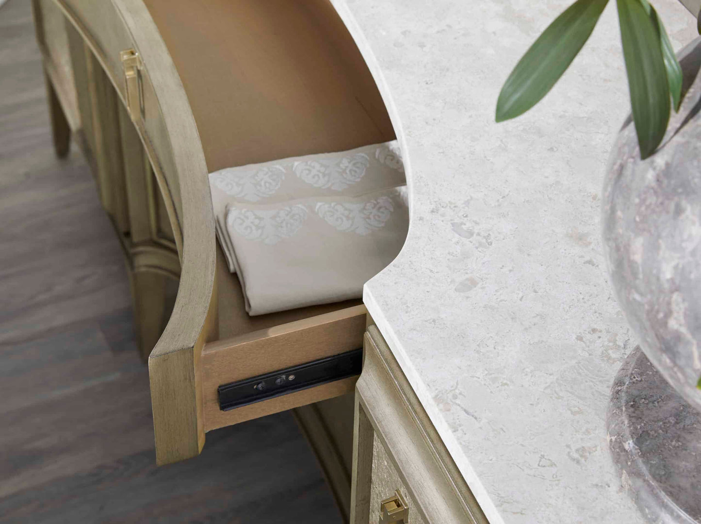 Close-up of drawer detail on transitional credenza with marble top and cork accents.