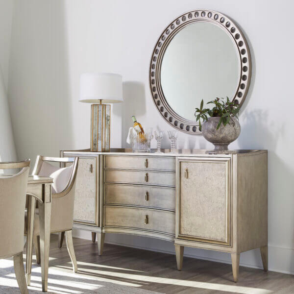 Elegant room setting featuring a transitional credenza with marble top and decorative accents