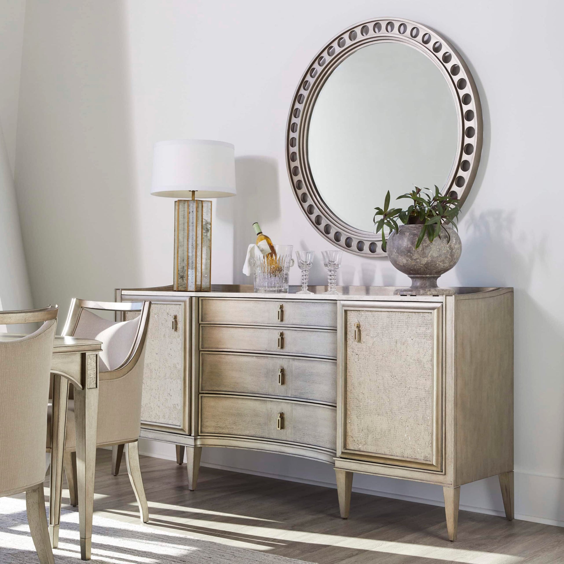 Transitional dining arm chairs arranged around a dining table near a buffet table, emphasizing the versatile and timeless appeal of the chairs.