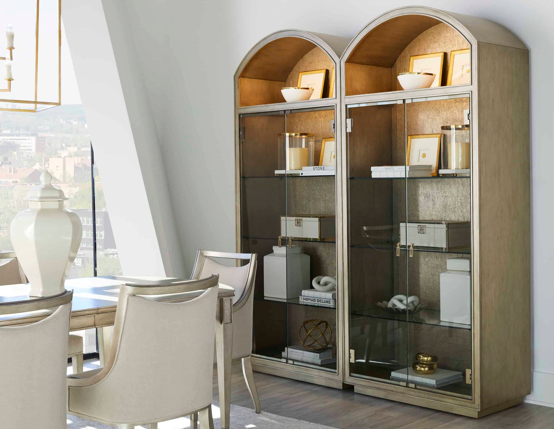  Transitional dining arm chairs placed next to a display cabinet, showing the chic and sophisticated look of the dining space.