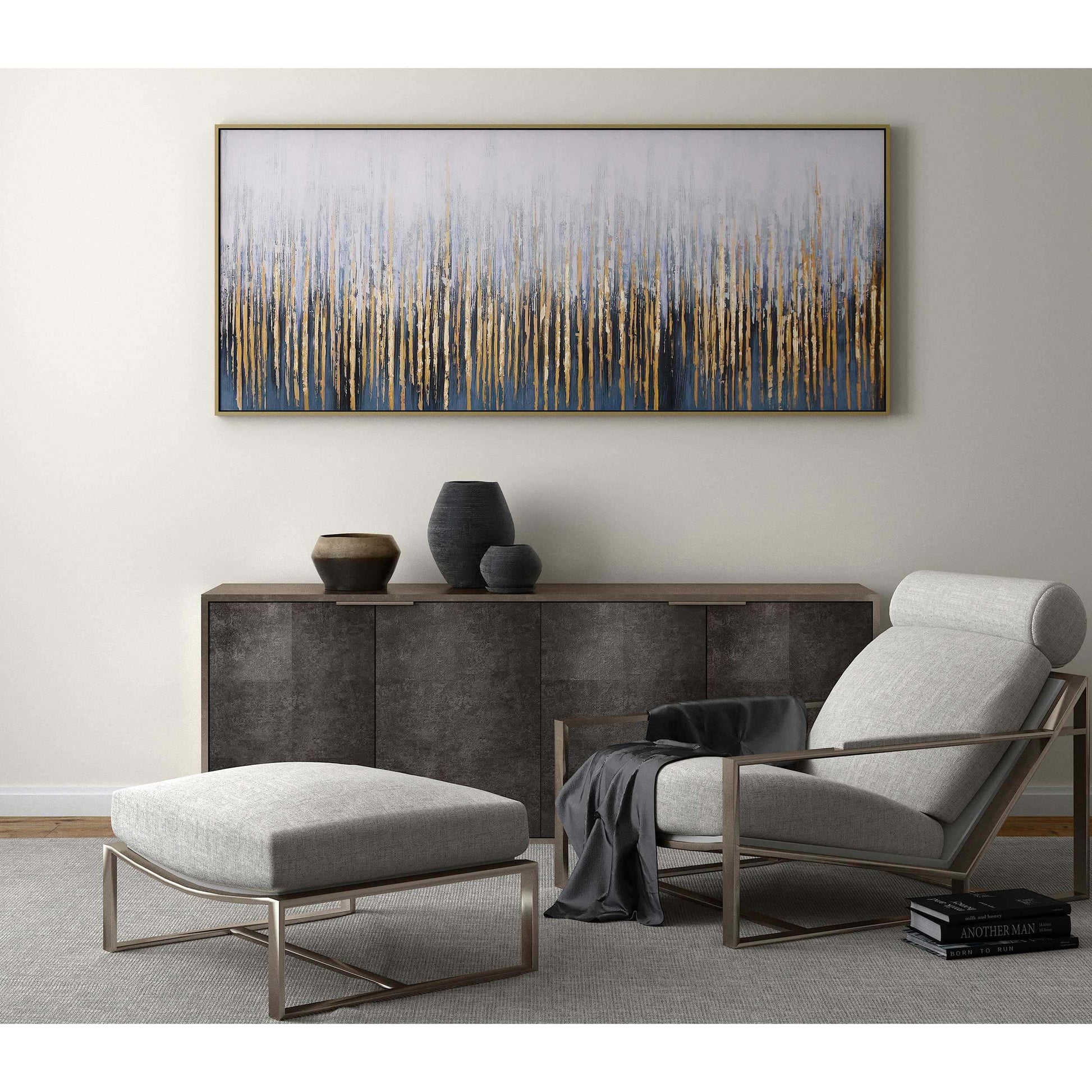 Contemporary gold wall art above a modern console table with neutral décor accents.