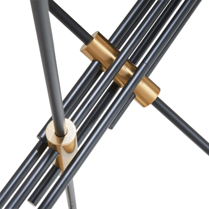 Spartan cylinder pendant light detail showing black arms and gold connectors.