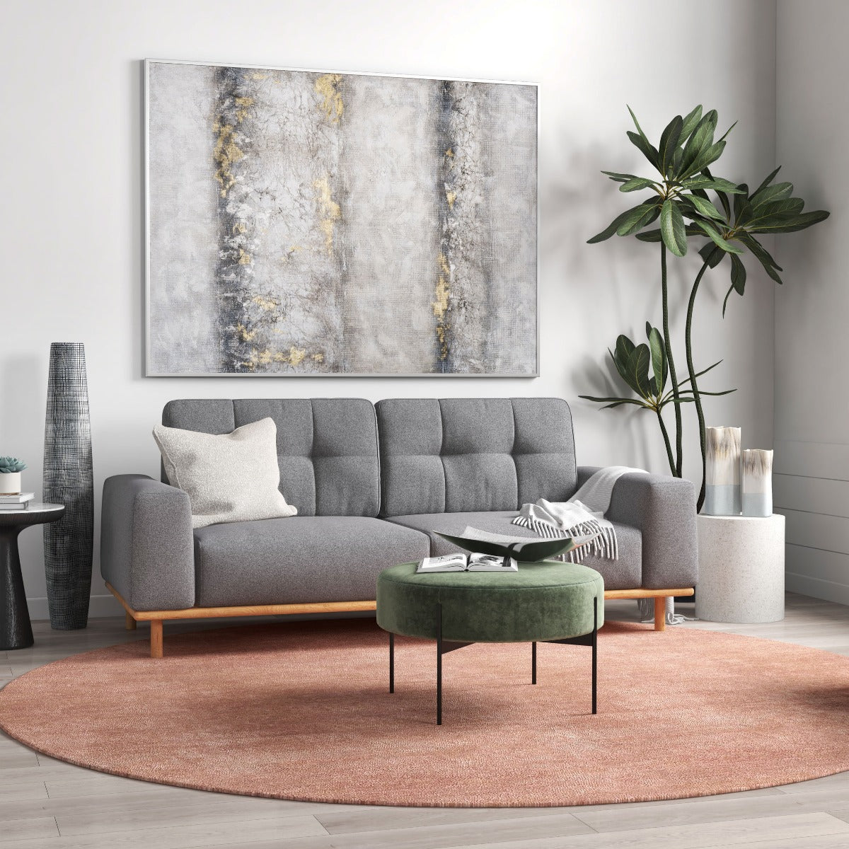 Contemporary grey and gold abstract wall art above a modern grey sofa with a green ottoman.