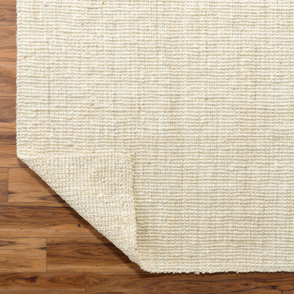 Durable, natural jute rug folded to display flexible construction.