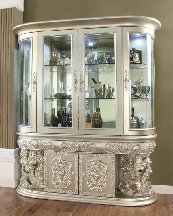 Baroque-style silver china cabinet with ornate carvings, glass display doors, and integrated lighting by Homey Design.