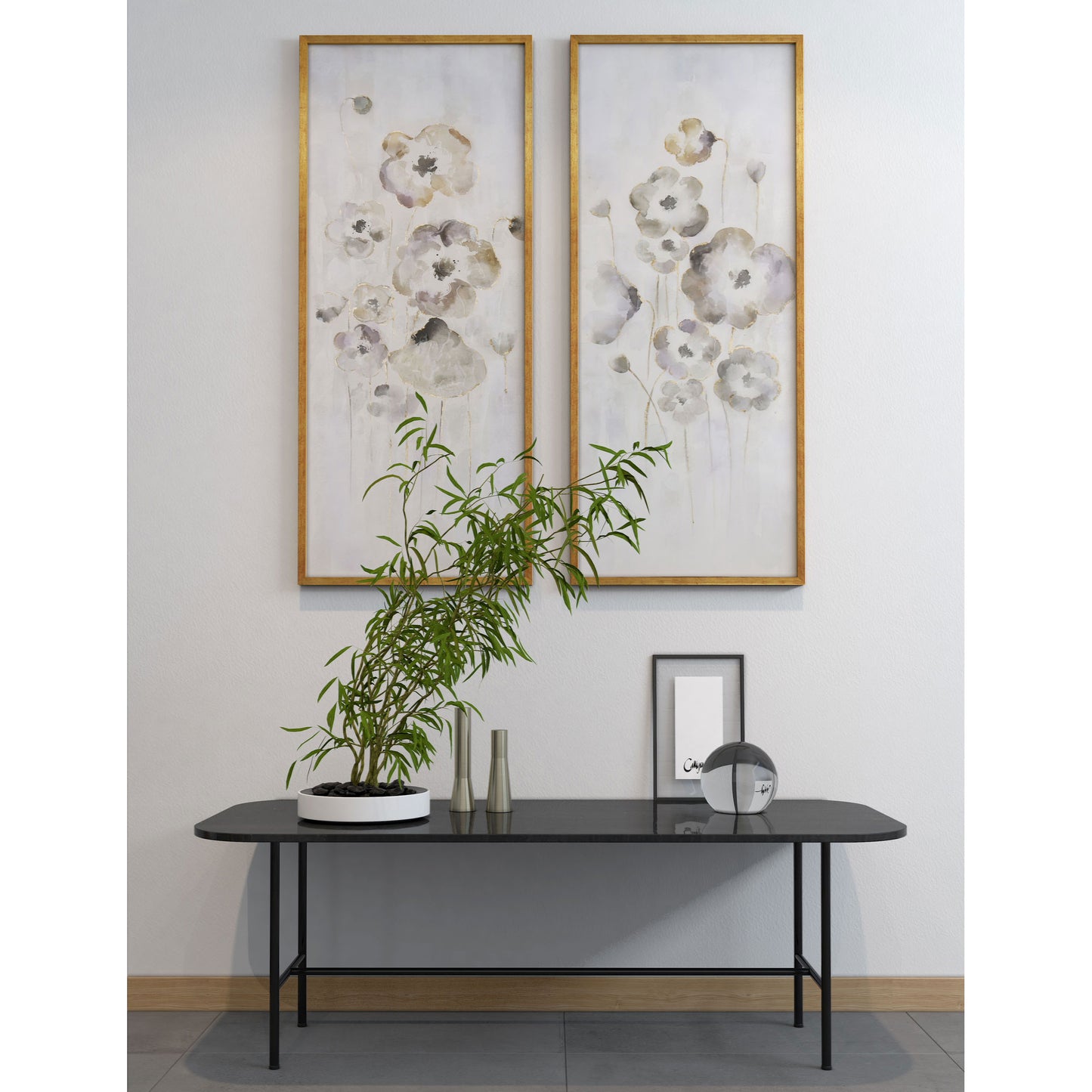 Floral painting set arranged above a console table with minimalist décor elements.