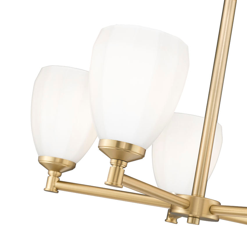 Close-up of modern gold chandelier arms and tulip-inspired opal glass shades.