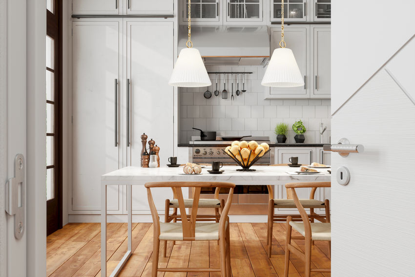 gold pendants over white marble dining space.