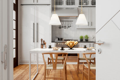 gold pendants over white marble dining space.