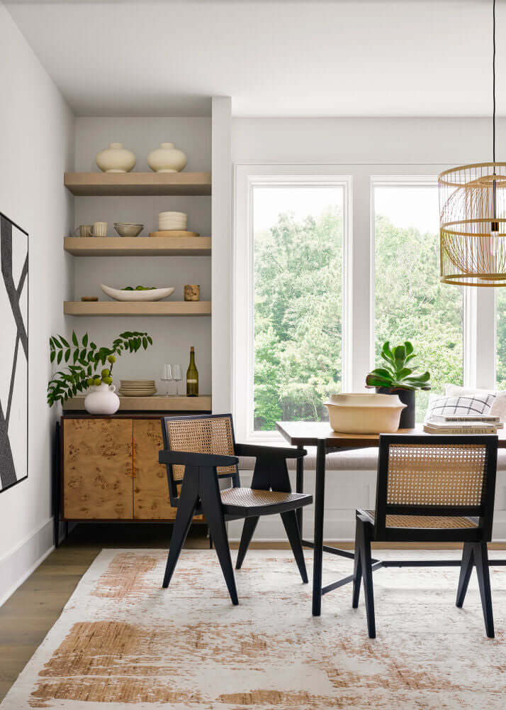 Contemporary dining room setup with Hague Dining Chairs in black, complementing a modern and airy space.