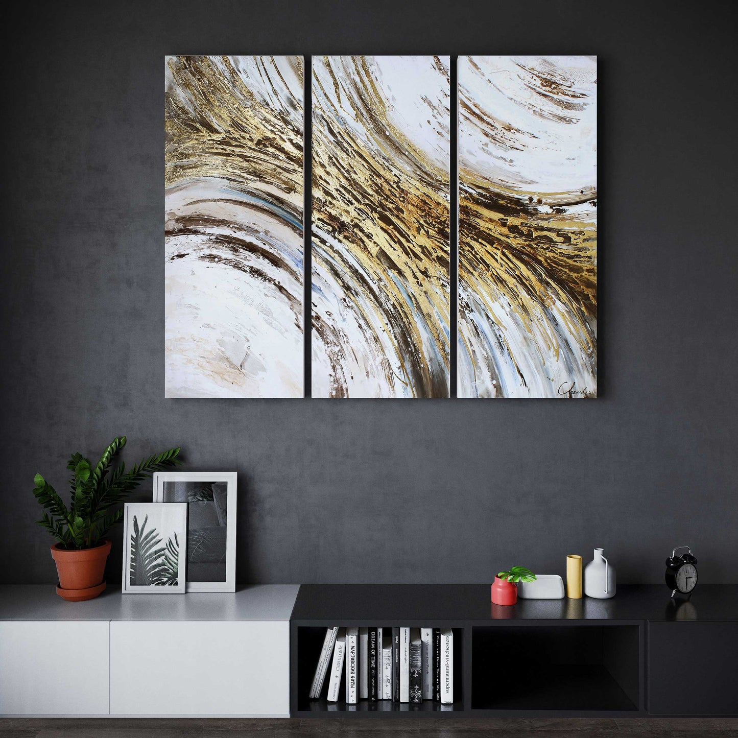 Three-panel abstract wall art with gold leaf and blue-gray tones, mounted above a modern console.