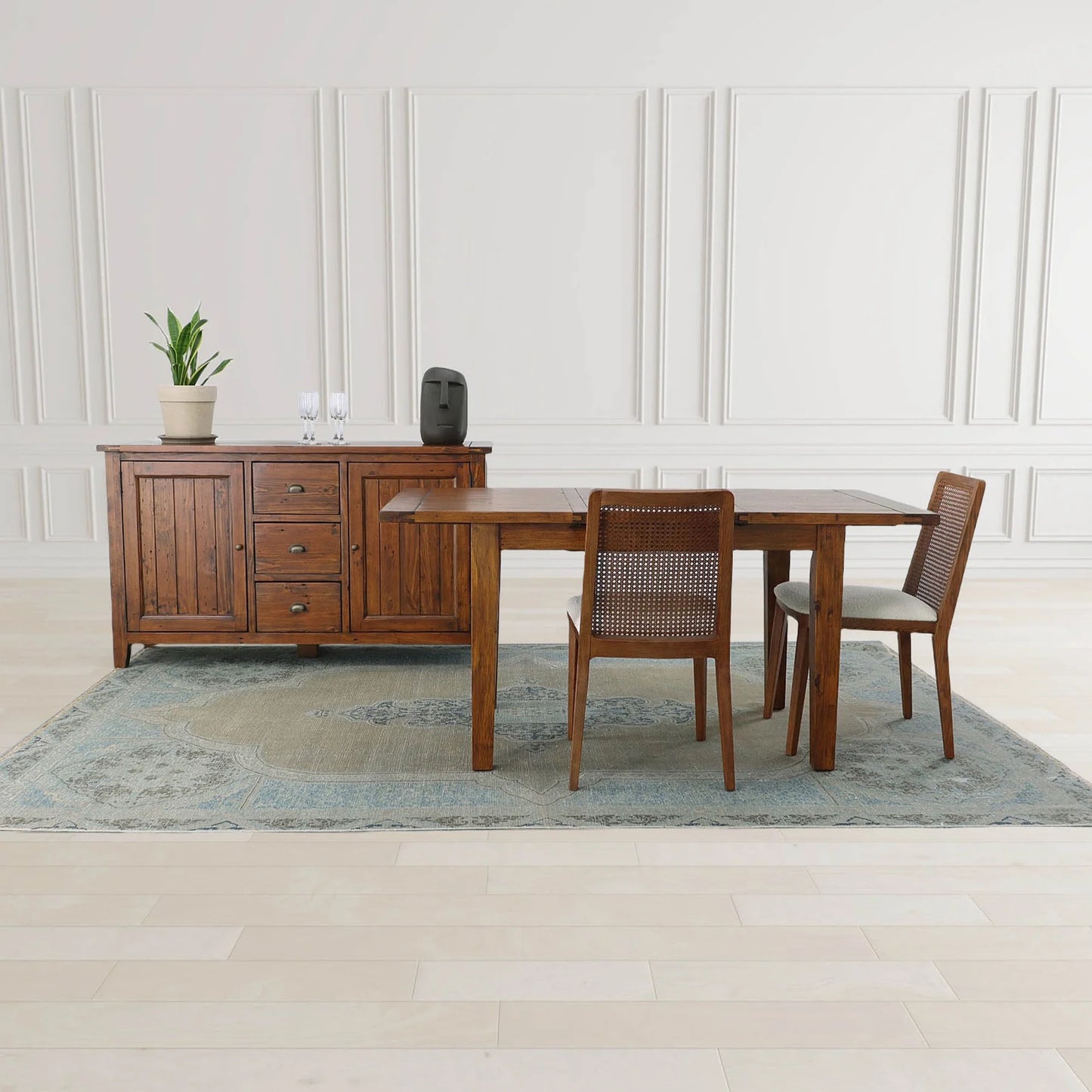 Irish Coast Large Brown Wood Sideboard in African Dusk finish displayed with table and chairs in modern setting.