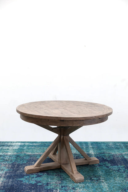 Side angle view of the Irish Coast round extension dining table, showcasing its sturdy pedestal base.