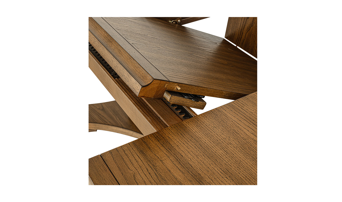 Close-up view of the self-storage butterfly extension mechanism on the Jamie extension dining table in vintage brown.