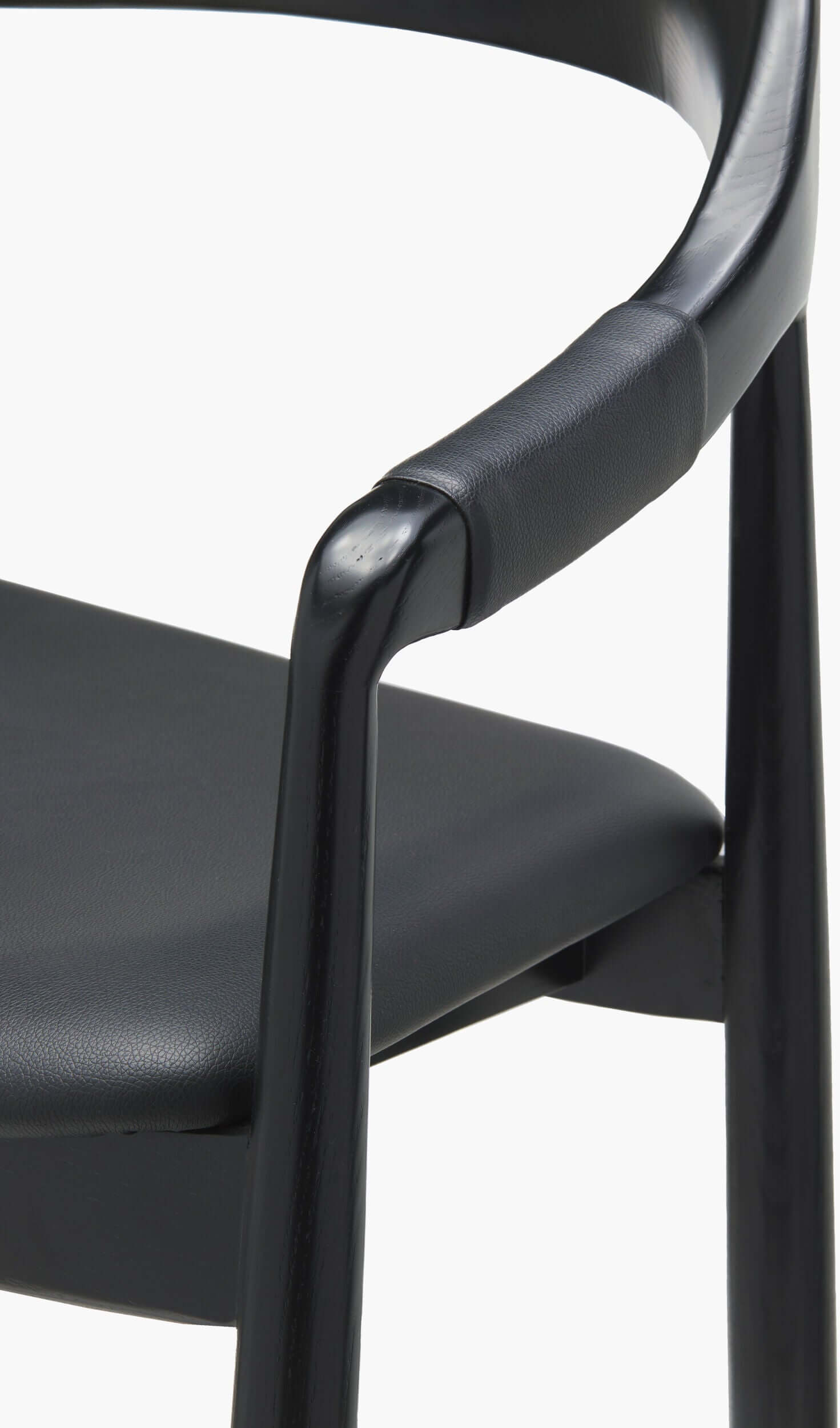 Detailed view of the armrest on the Kisco Bar Stool by Surya, highlighting the smooth black wooden finish and comfortable padding.