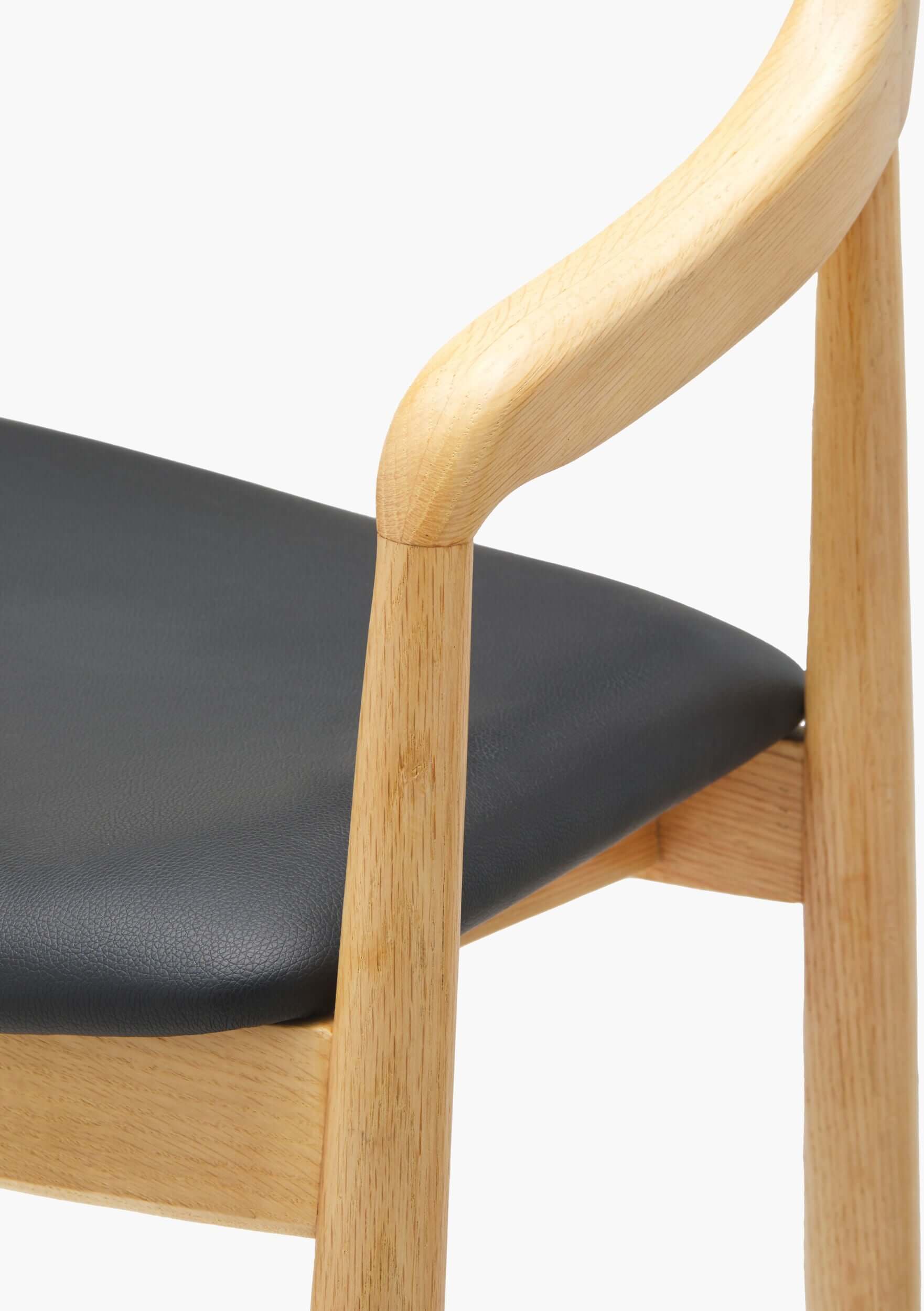 Detailed view of the armrest padding on the Kisco Natural Bar Stool by Surya, showcasing the high-quality faux leather and ergonomic design.