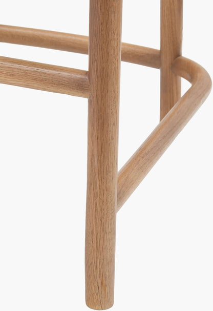 Close-up of the leg design and oak wood finish on the Keating Bar Stool.