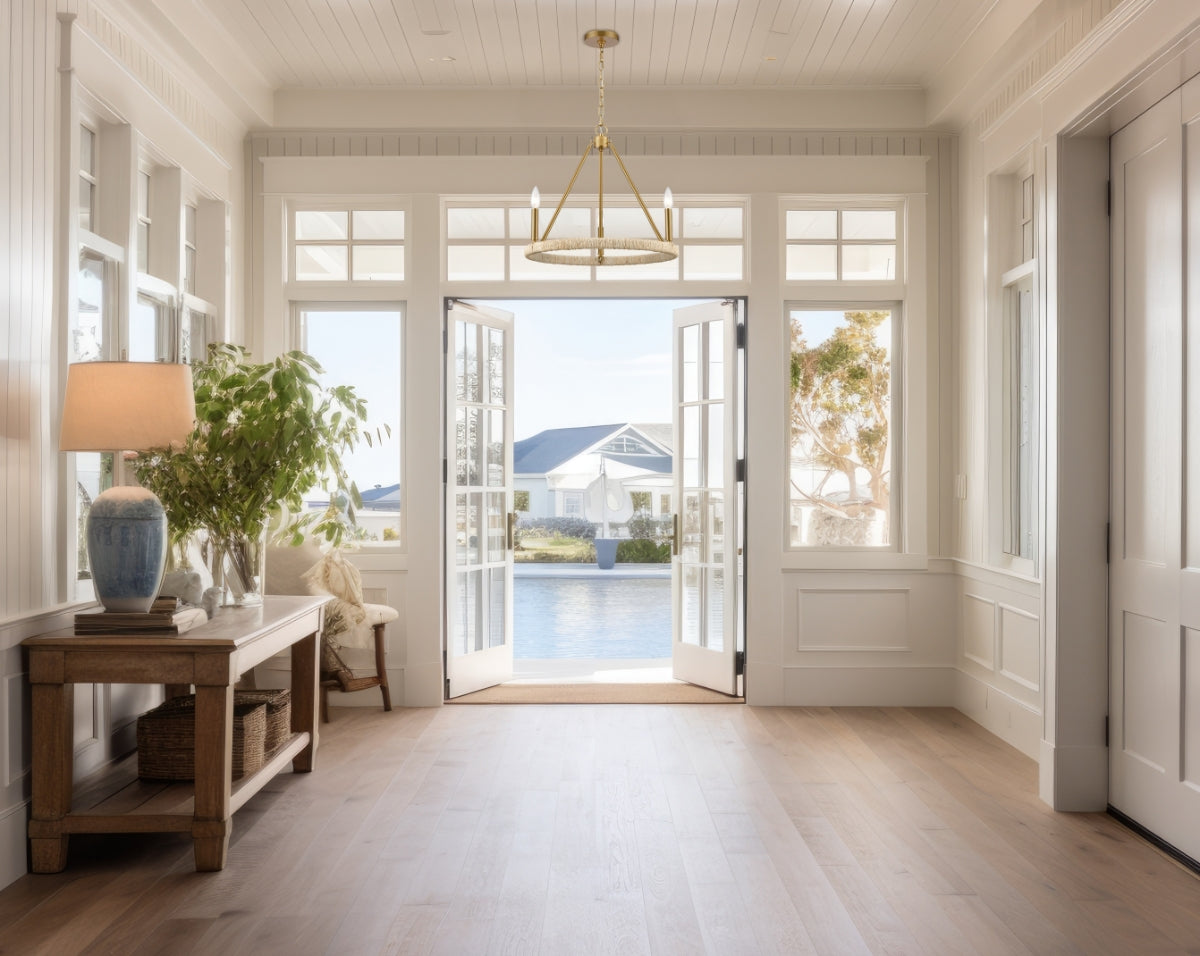 Lifestyle view of the Abaca chandelier in a modern entryway with large windows.