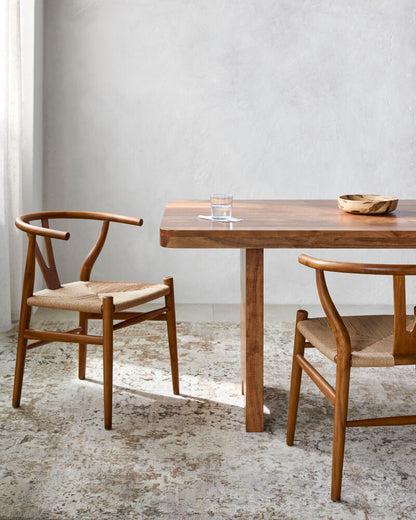 Linxia brown mid-century teak wood dining chairs styled in a mid-century modern room.