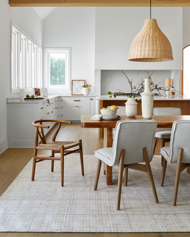 Linxia Modern Teak wood dining chairs with handwoven seats displayed in a dining room setting.