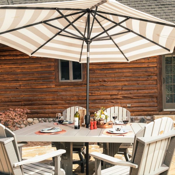 LuxCraft patio umbrella in Solana Seagull, set up over a dining table in a rustic outdoor setting.