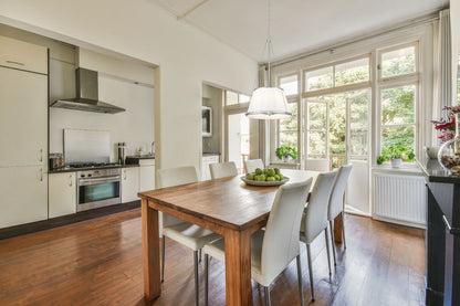 modern six-light pendant over dining table with natural wood finish.