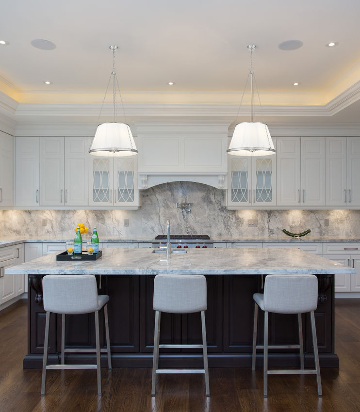 polished nickel pendant light illuminating elegant kitchen space.