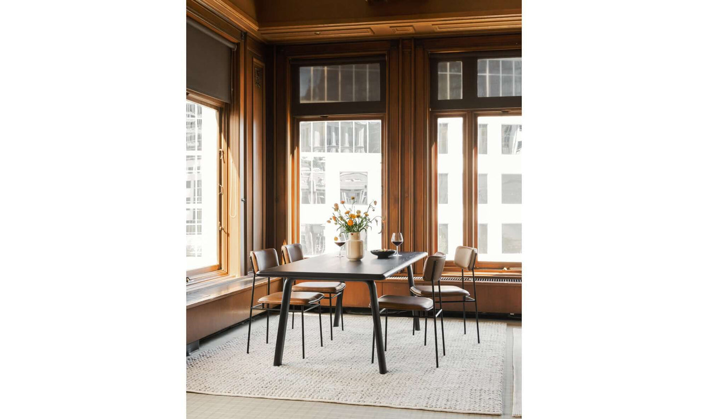 Malibu Black Dining Table in a modern dining room setting with seating for four.