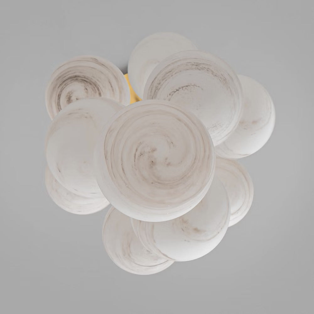 Close-up of chandelier globes with a marble-textured finish, showcasing intricate craftsmanship.