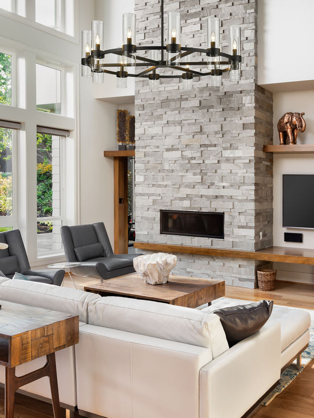 matte black contemporary chandelier hanging over stone fireplace.