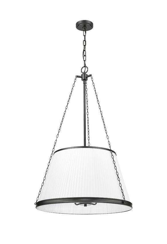 matte black pendant light glowing warmly through pleated white fabric shade.