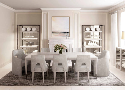 Sleek grey dining arm chairs around a rectangular dining table in a minimalist room.