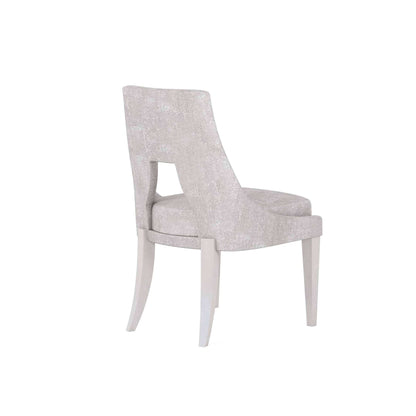 Elegant traditional fabric dining chair with minimalist design, showcasing its back and cut-out detail.