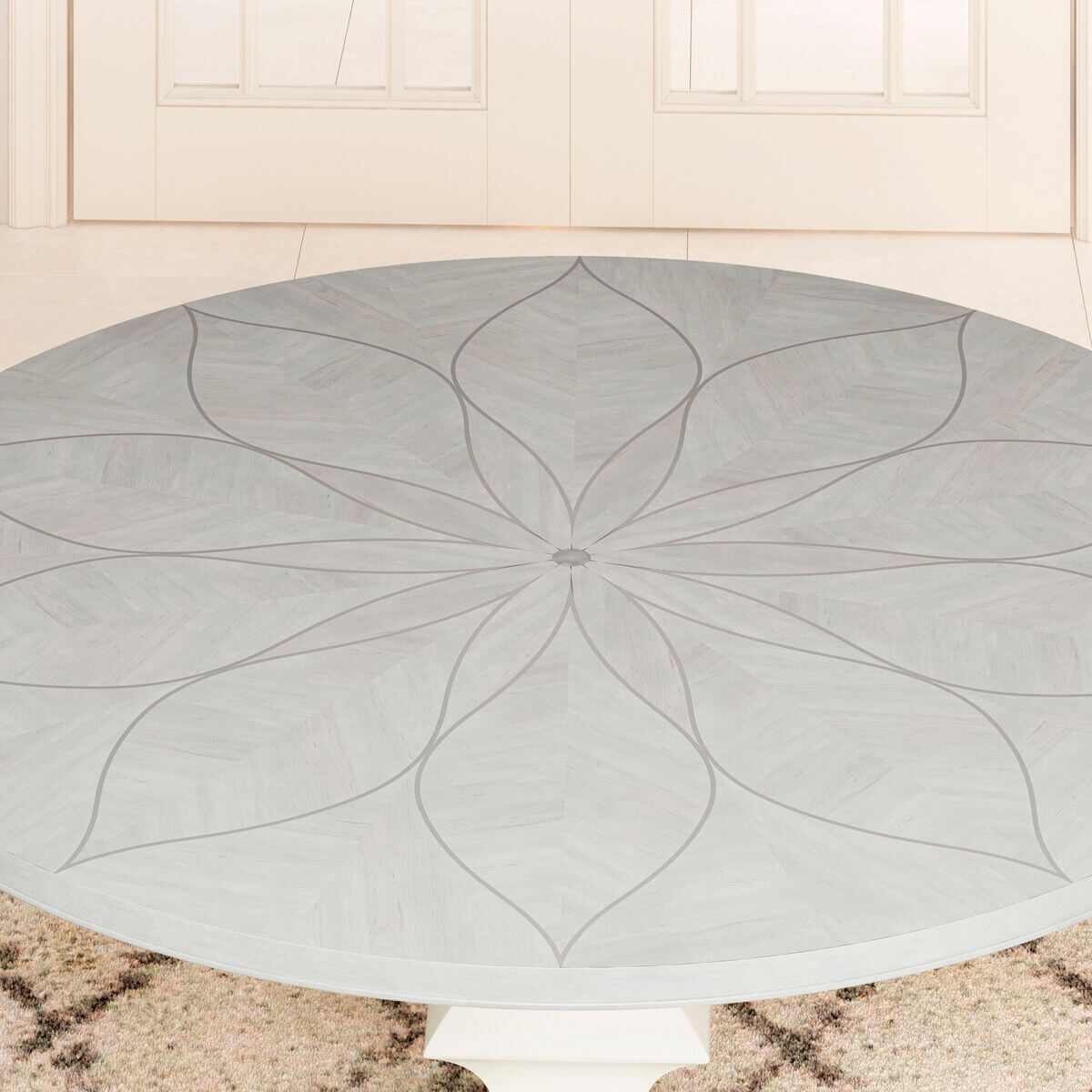 Close-up of the Mezzanine Round Dining Table's detailed floral veneer inlay on the tabletop.